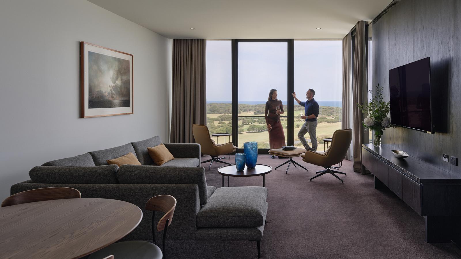 Ocean spa suite at RACV Torquay Resort, featuring a king bed, couches and desk.