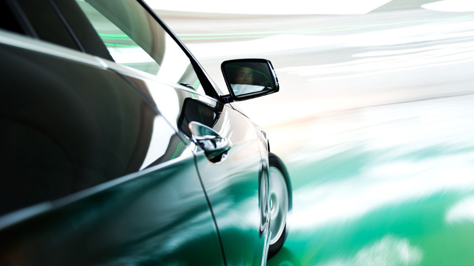 Side view of a dark car turning.