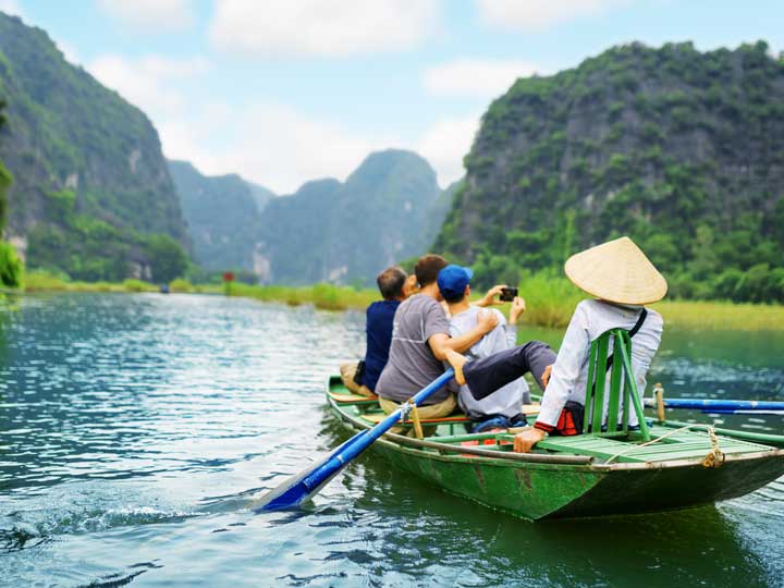Tourists being taken on a boat rip in a river in Vietnam.