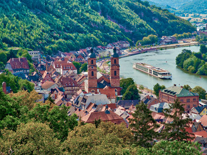 Old European town with a cruise ship going down the river