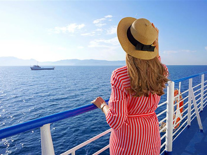 Woman admiring the ocean view on a cruise ship