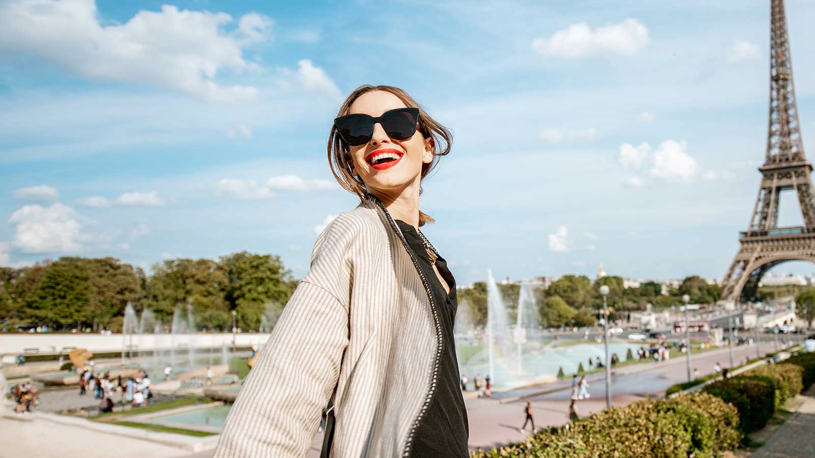 Woman standing in front of the Eiffel Tower in France